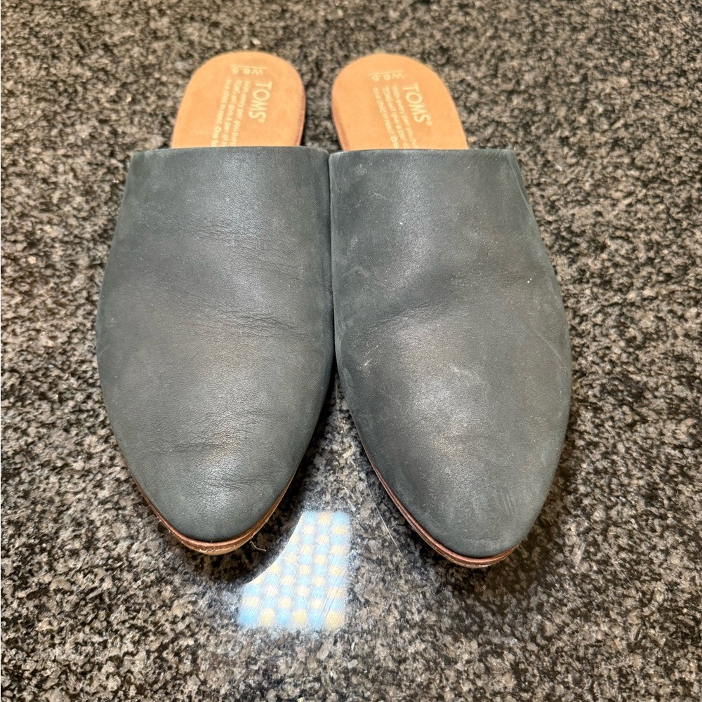 Black leather mules.